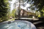 Relax in the hot tub in the forest with river views
